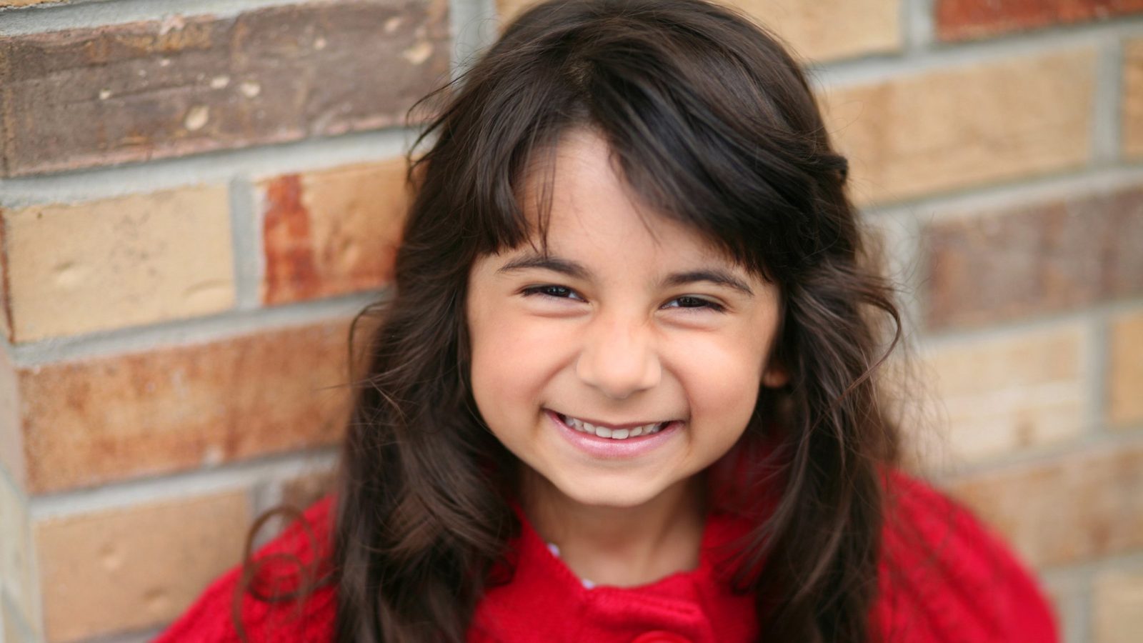 Smiling girl in a red top
