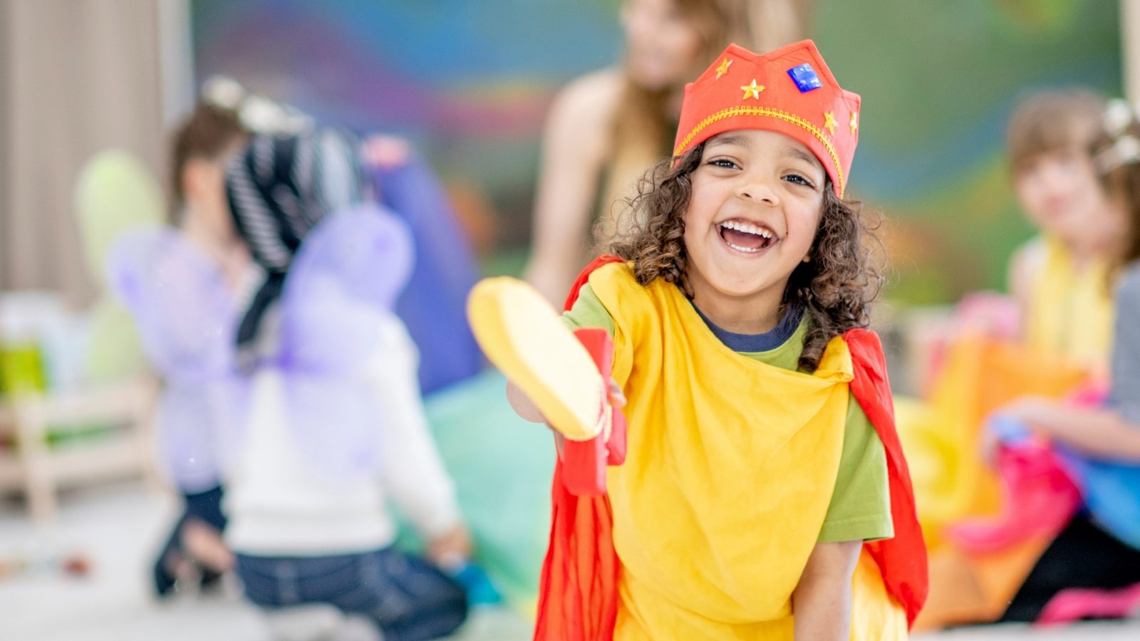 A girl in a superhero costume during pretend play
