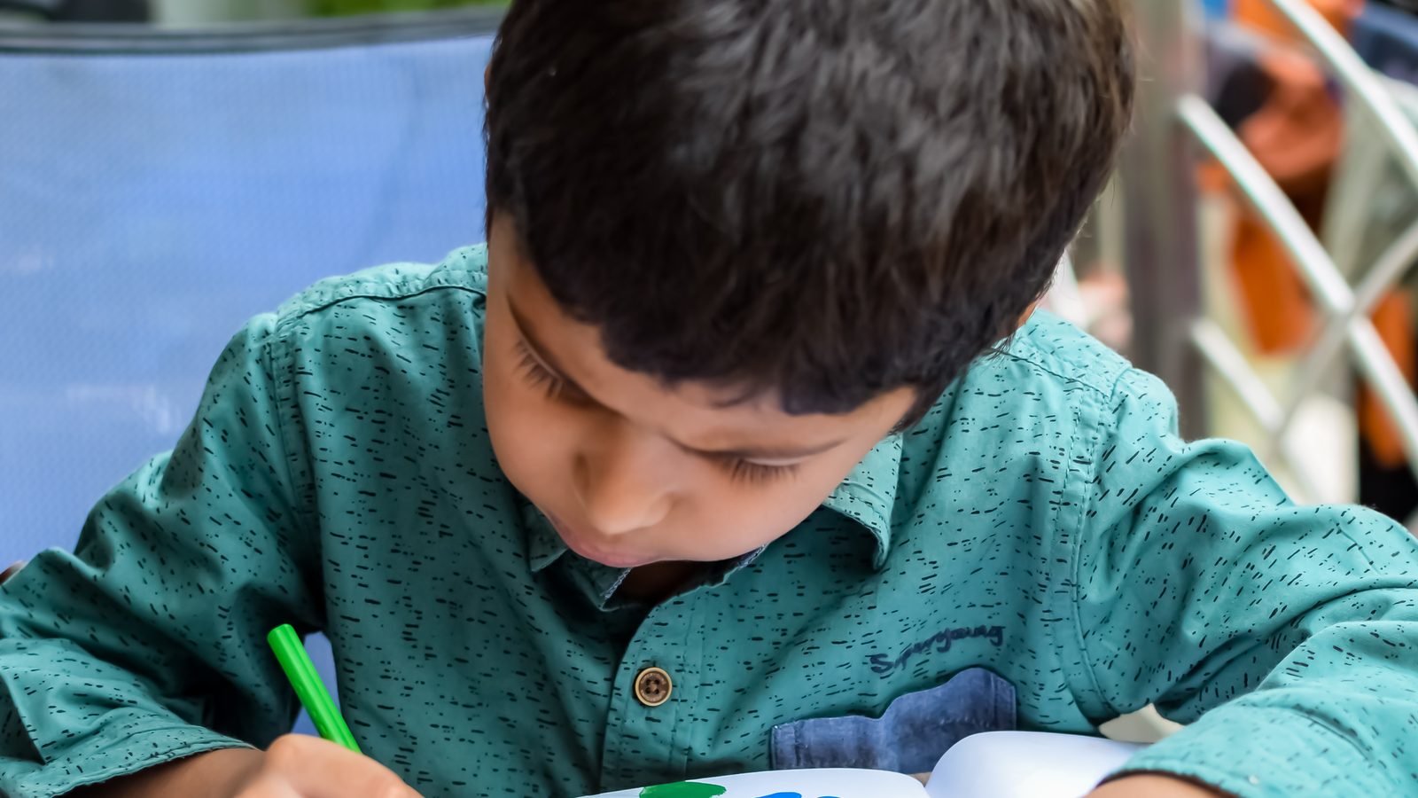 A boy drawing at his desk