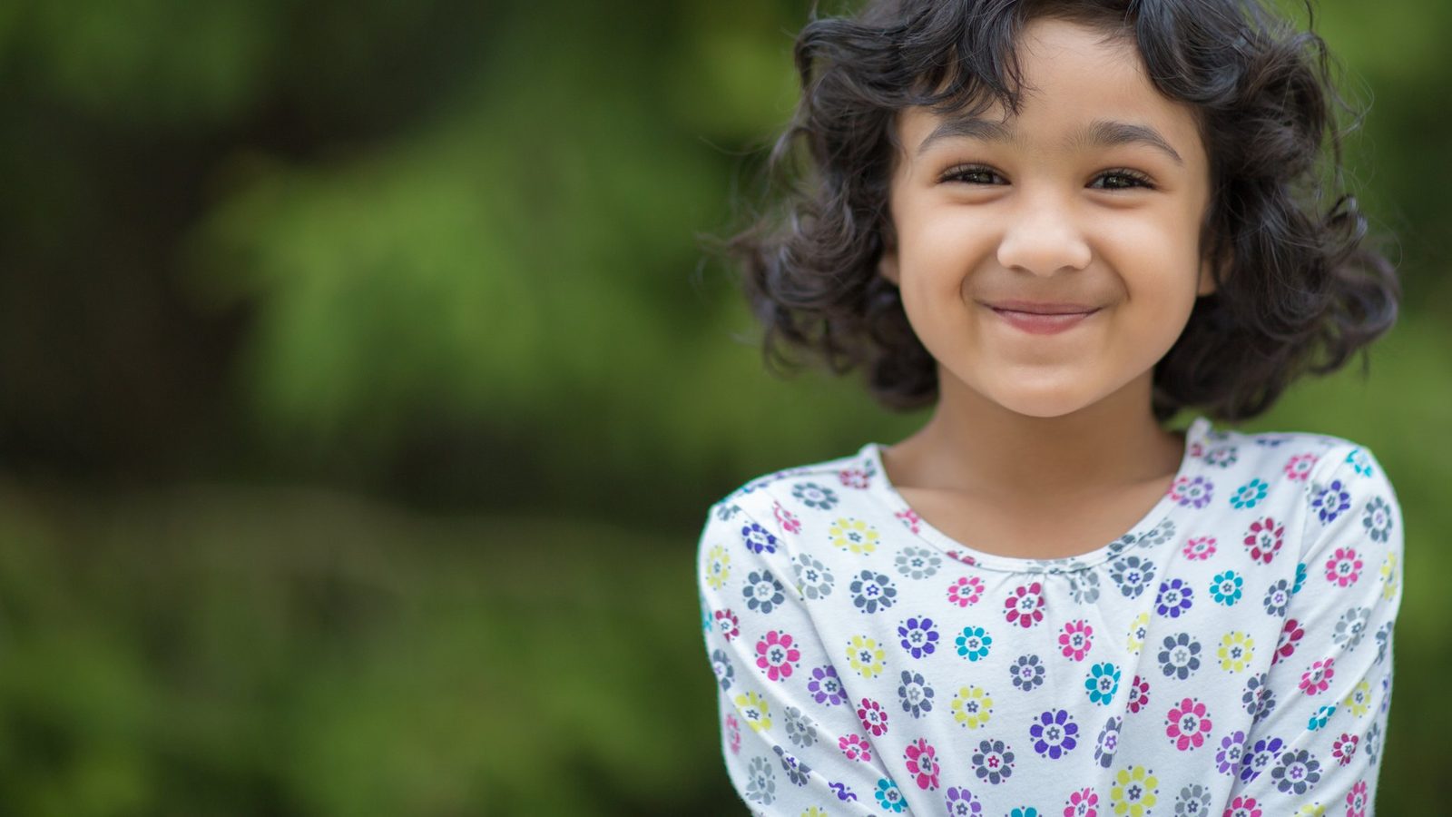 Smiling girl in a patterned dress