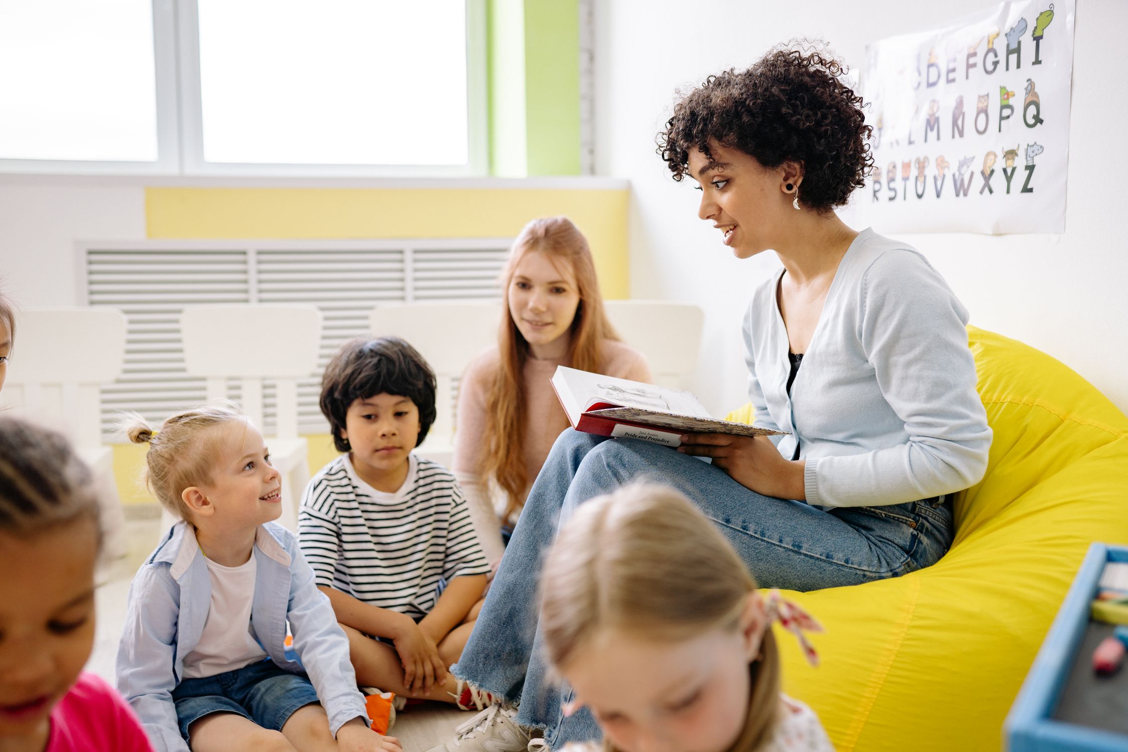 Preschool teacher reading to children