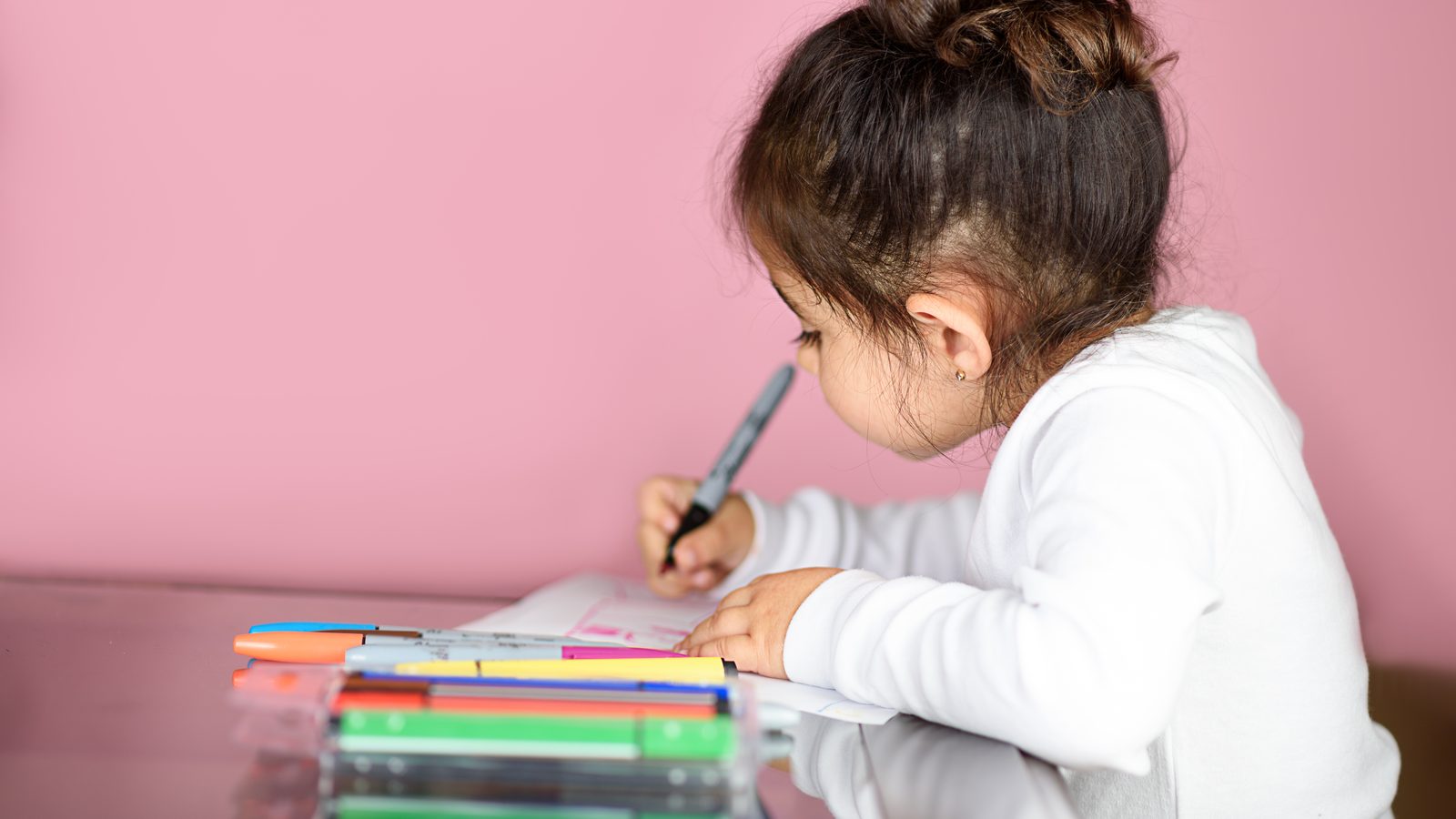 A girl drawing at a table