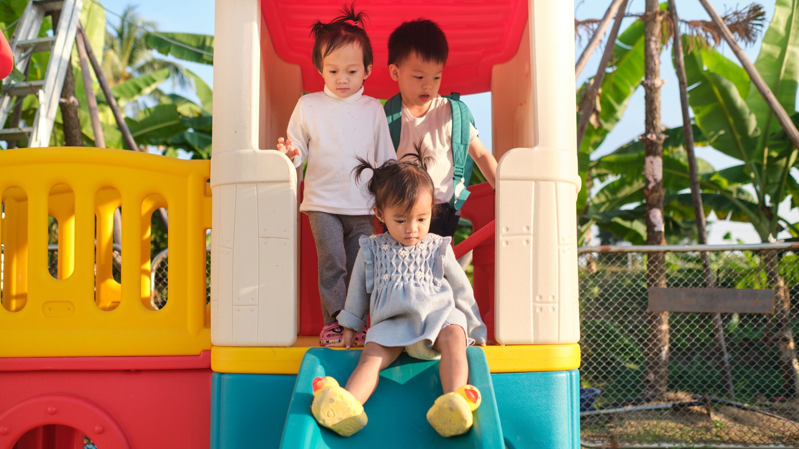Children on a playground play house