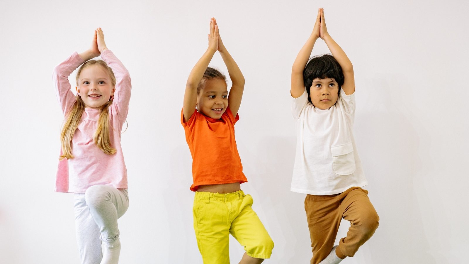 Children doing a yoga pose together