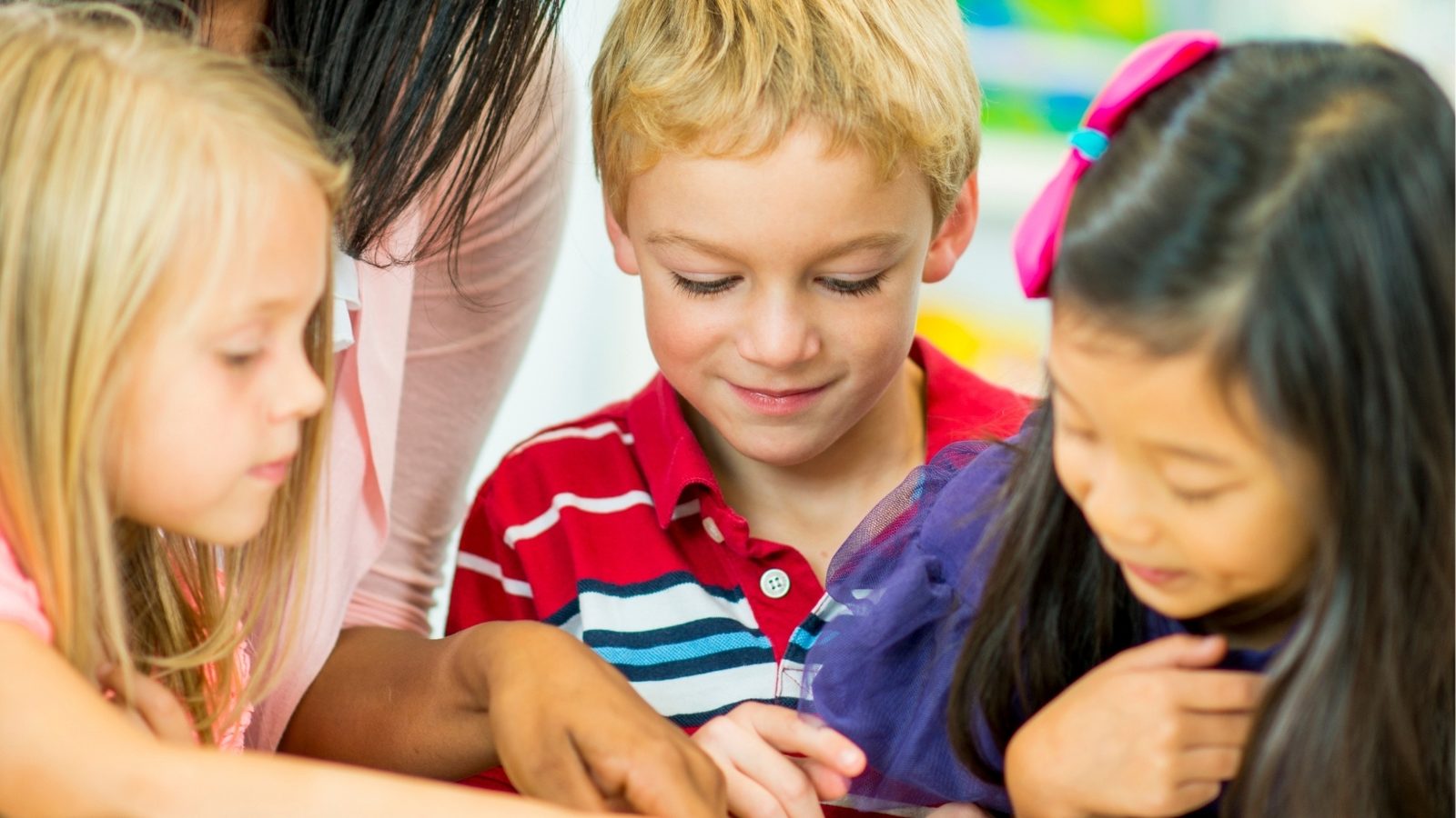 A teacher reading a story to preschool children