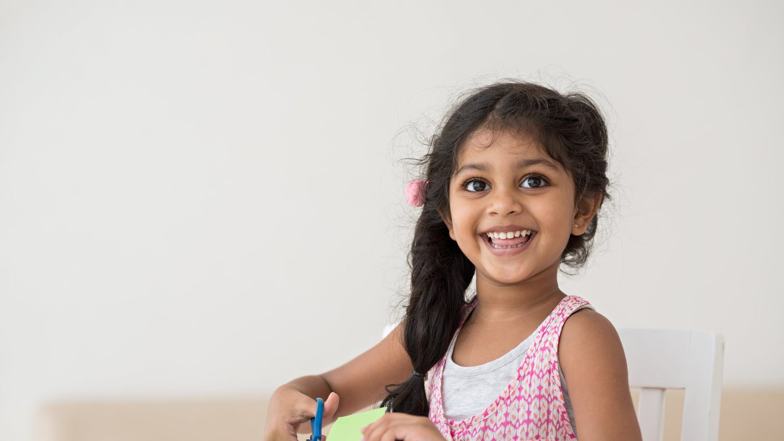Girl smiling at a desk