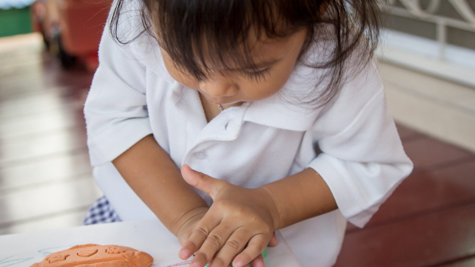 A child drawing at a table