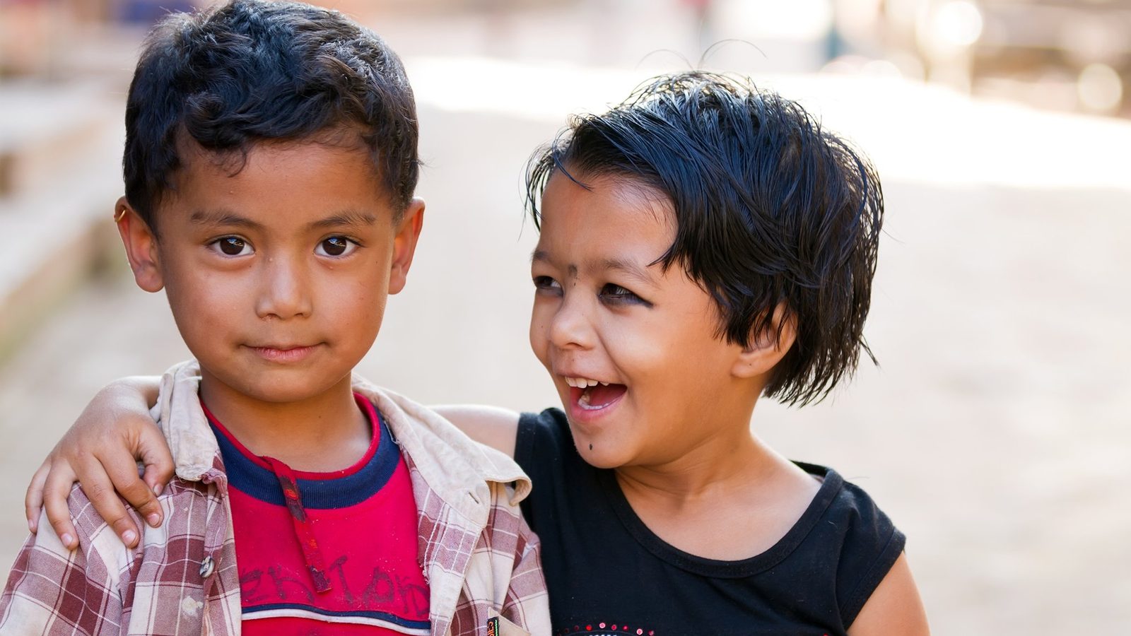 Two boys smiling together outdoors