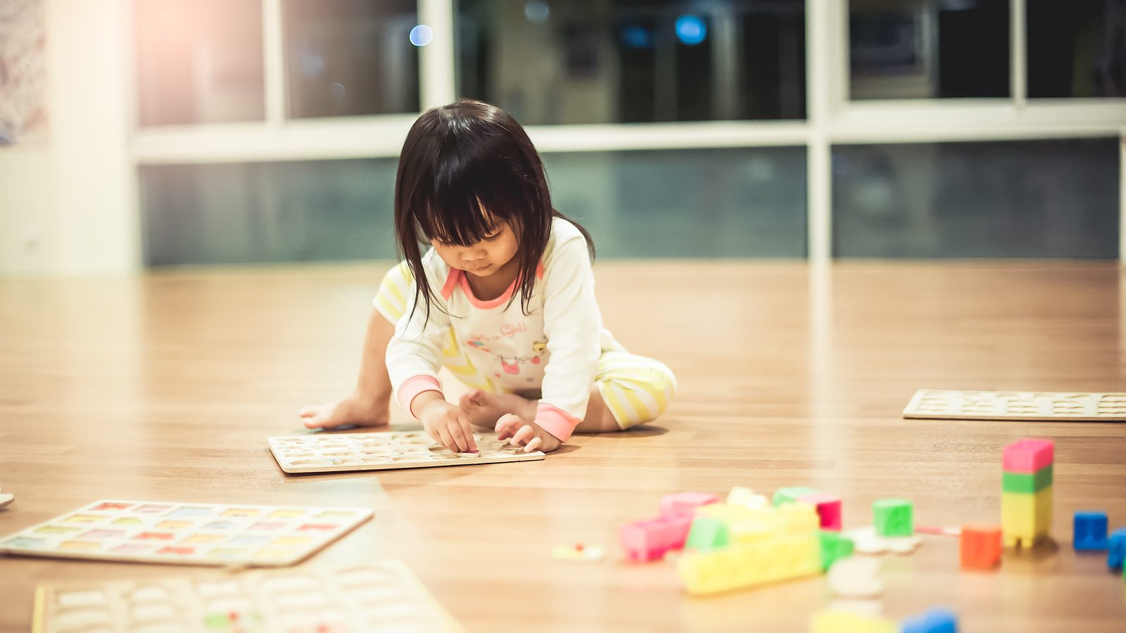A girl playing with toys at a table
