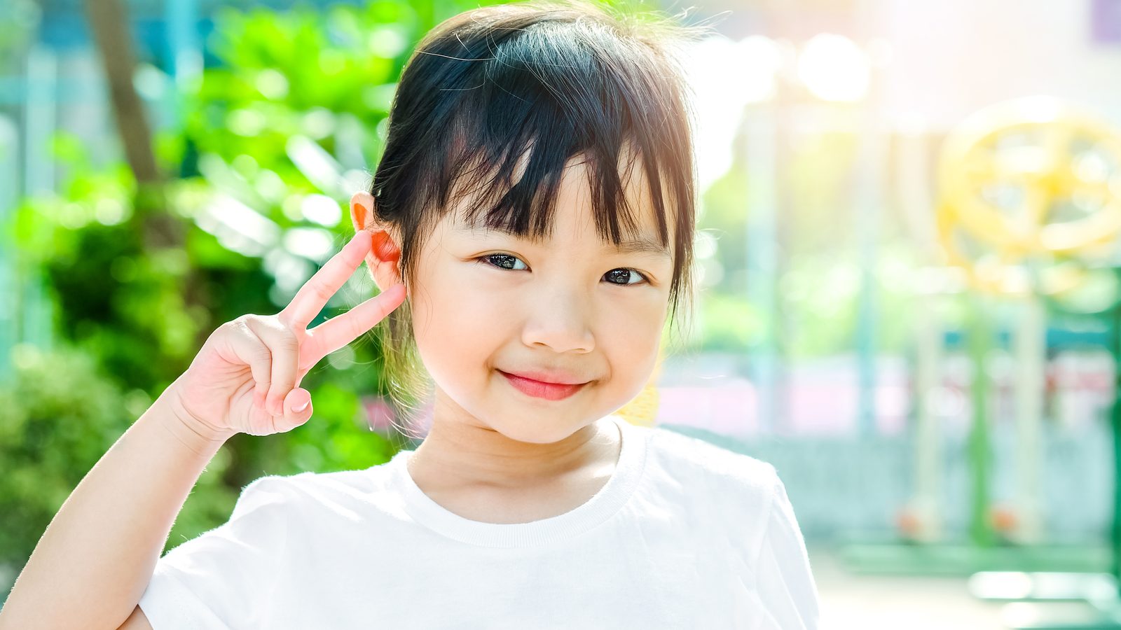 A smiling girl playing outdoors