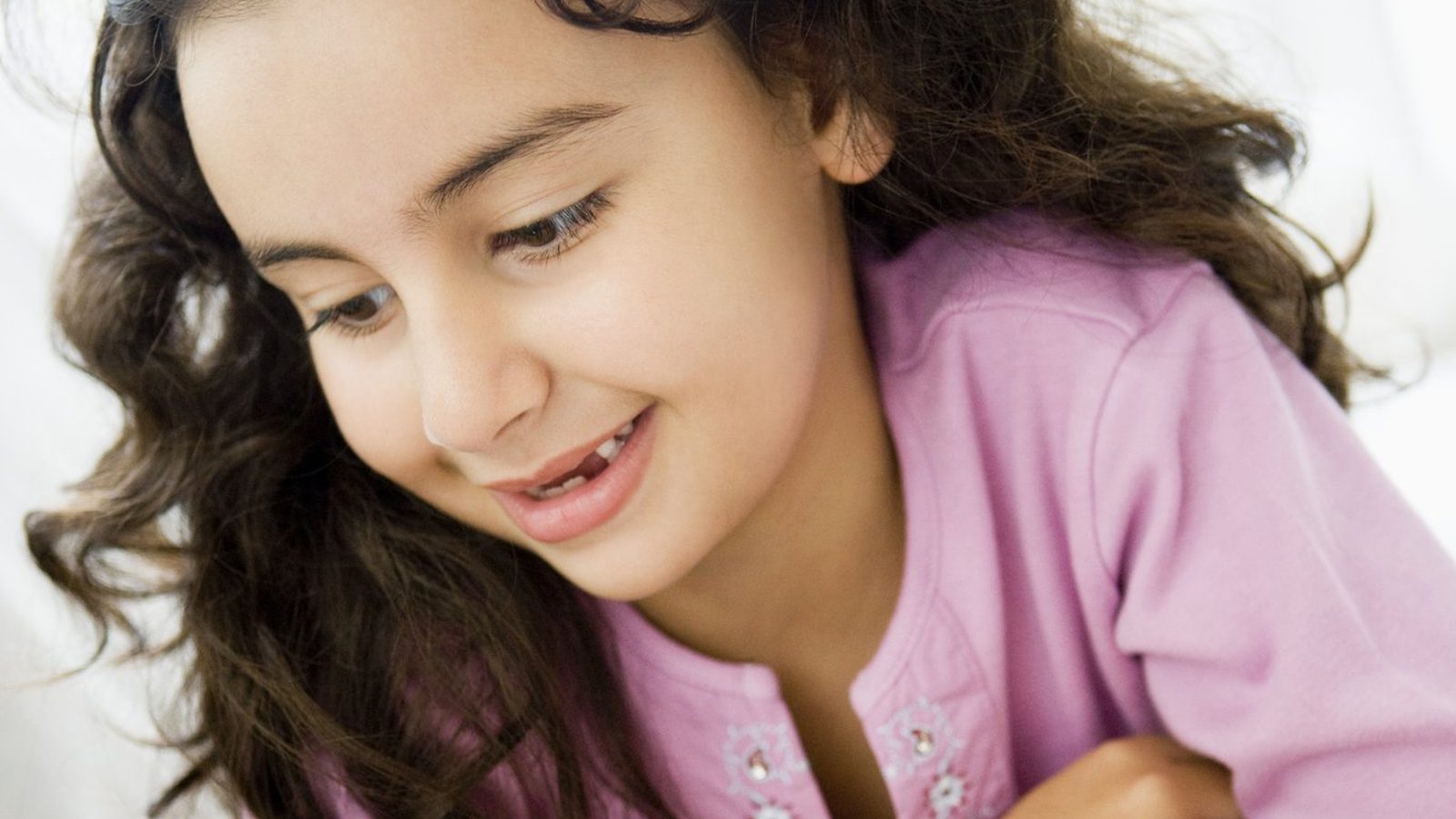 Girl reading a book on the floor