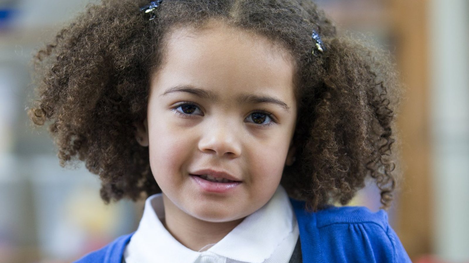 Girl in a school uniform smiling
