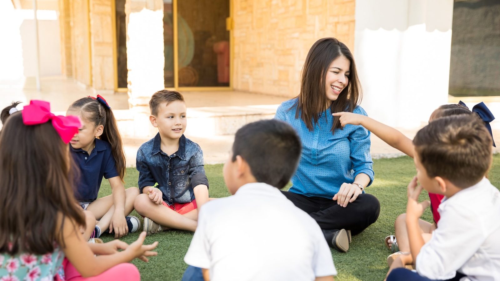 A teacher with children on the classroom carpet