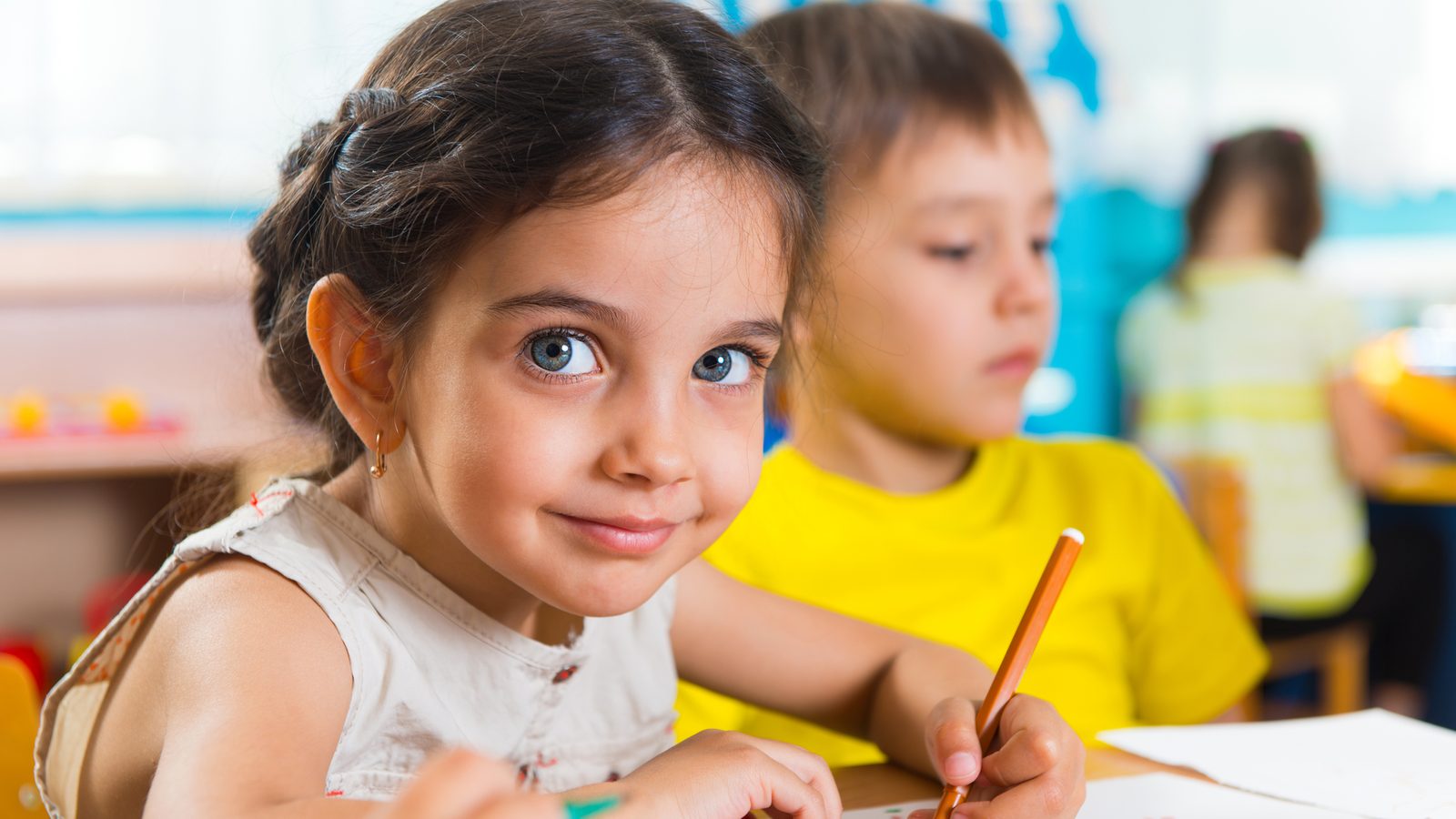 Children drawing together in a classroom