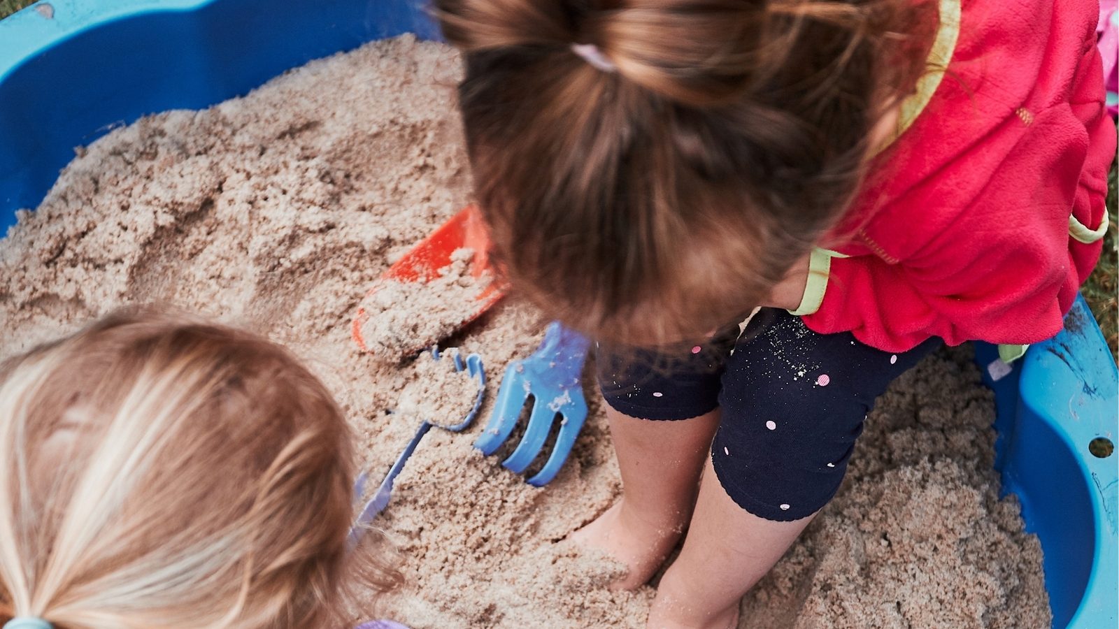A girl playing in a sandpit