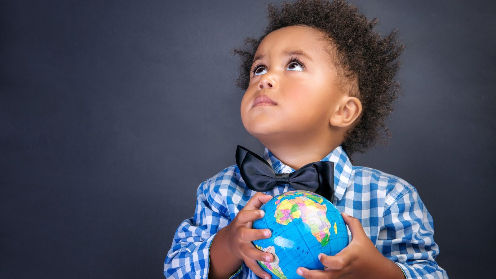 Boy holding a small globe