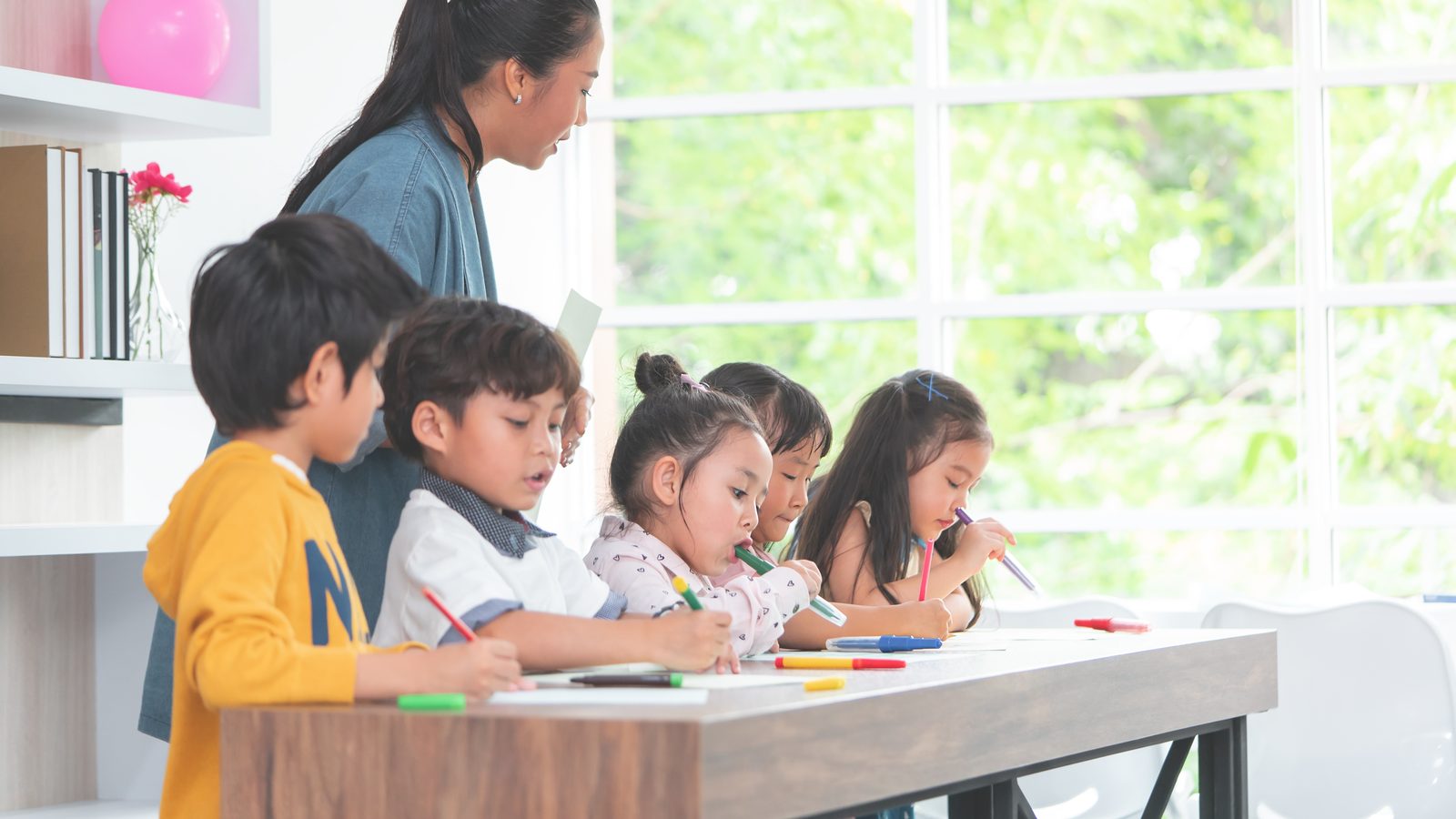 Children working at their classroom desks