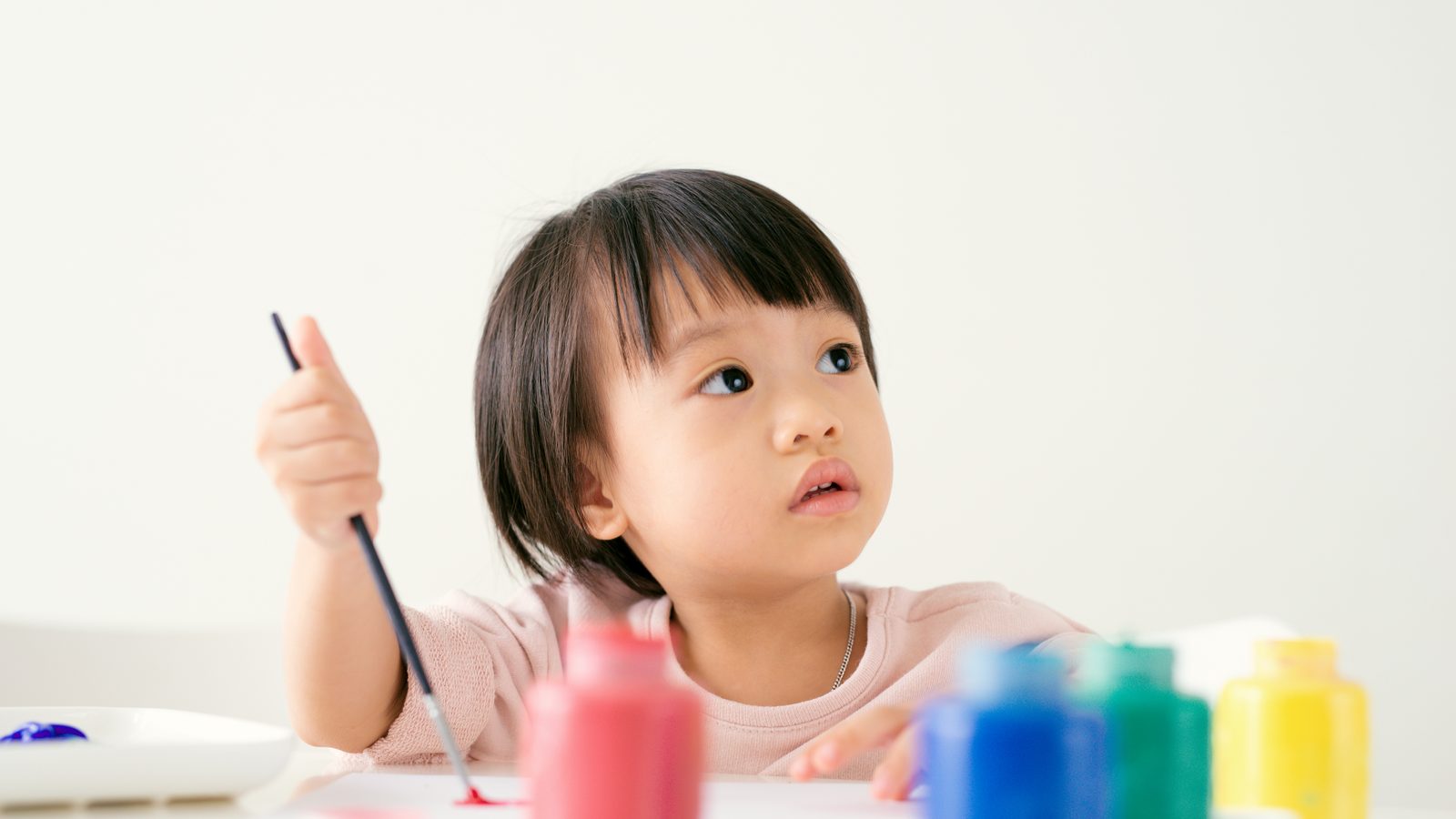 A girl painting at a table