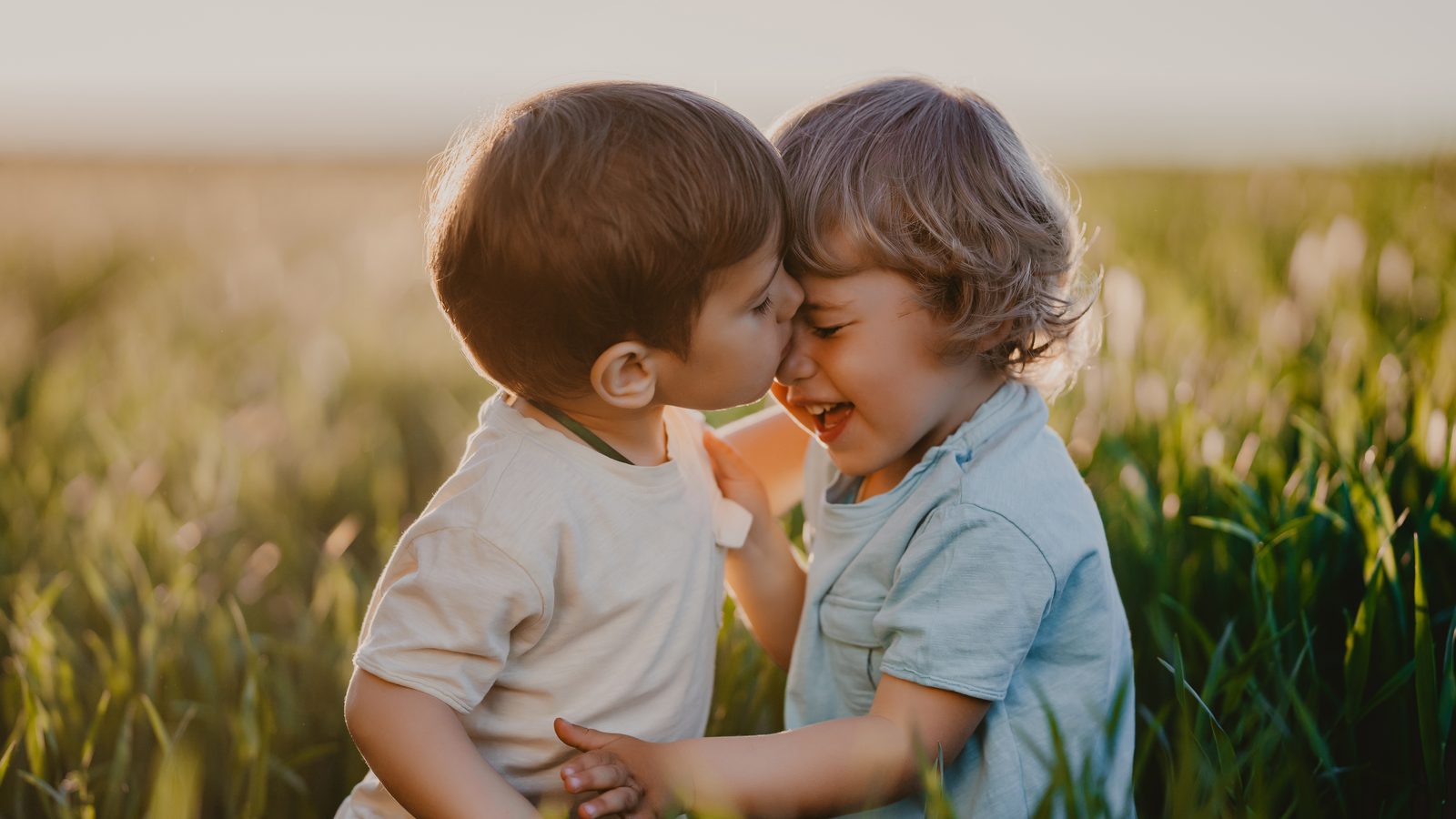 Two young boys playing in a field