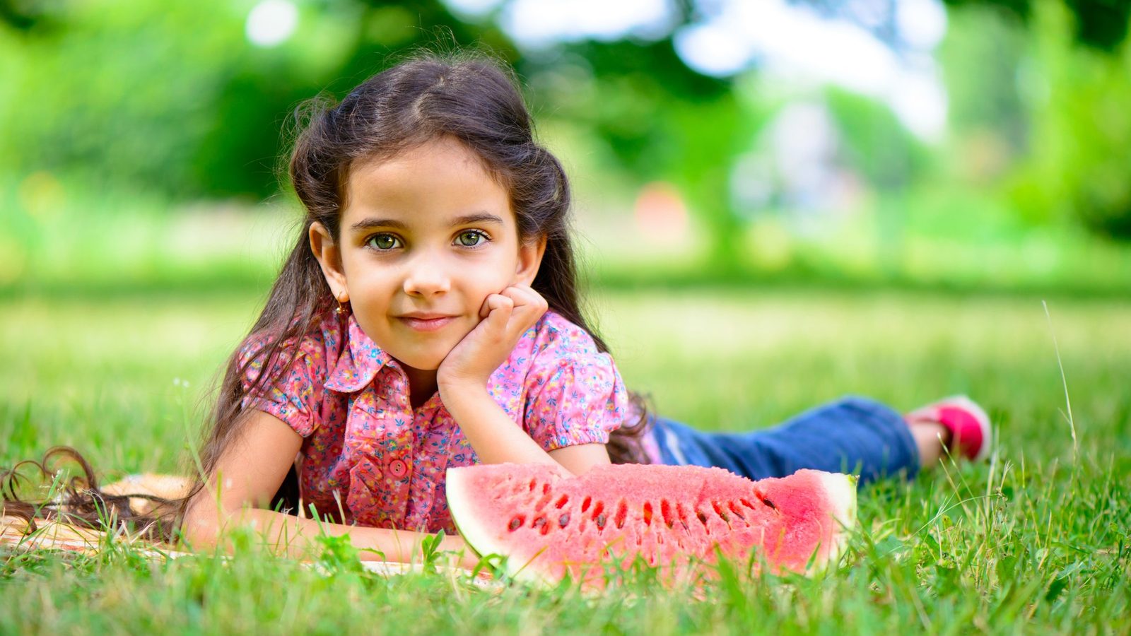 Girl lying on the grass smiling