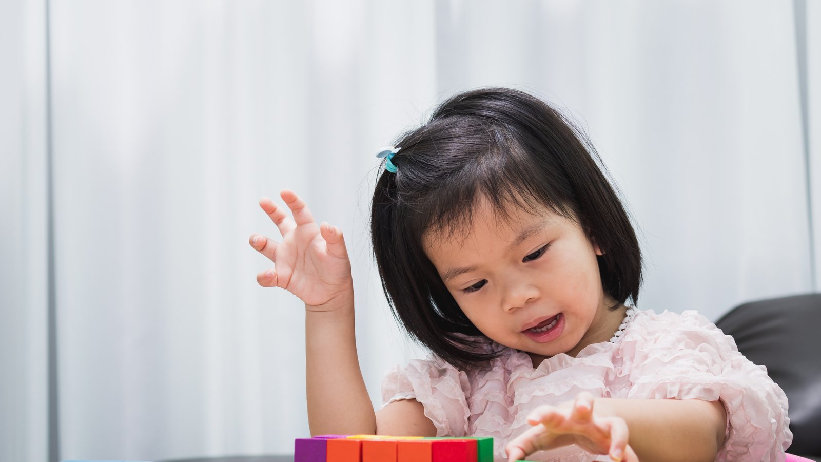 A girl building with blocks