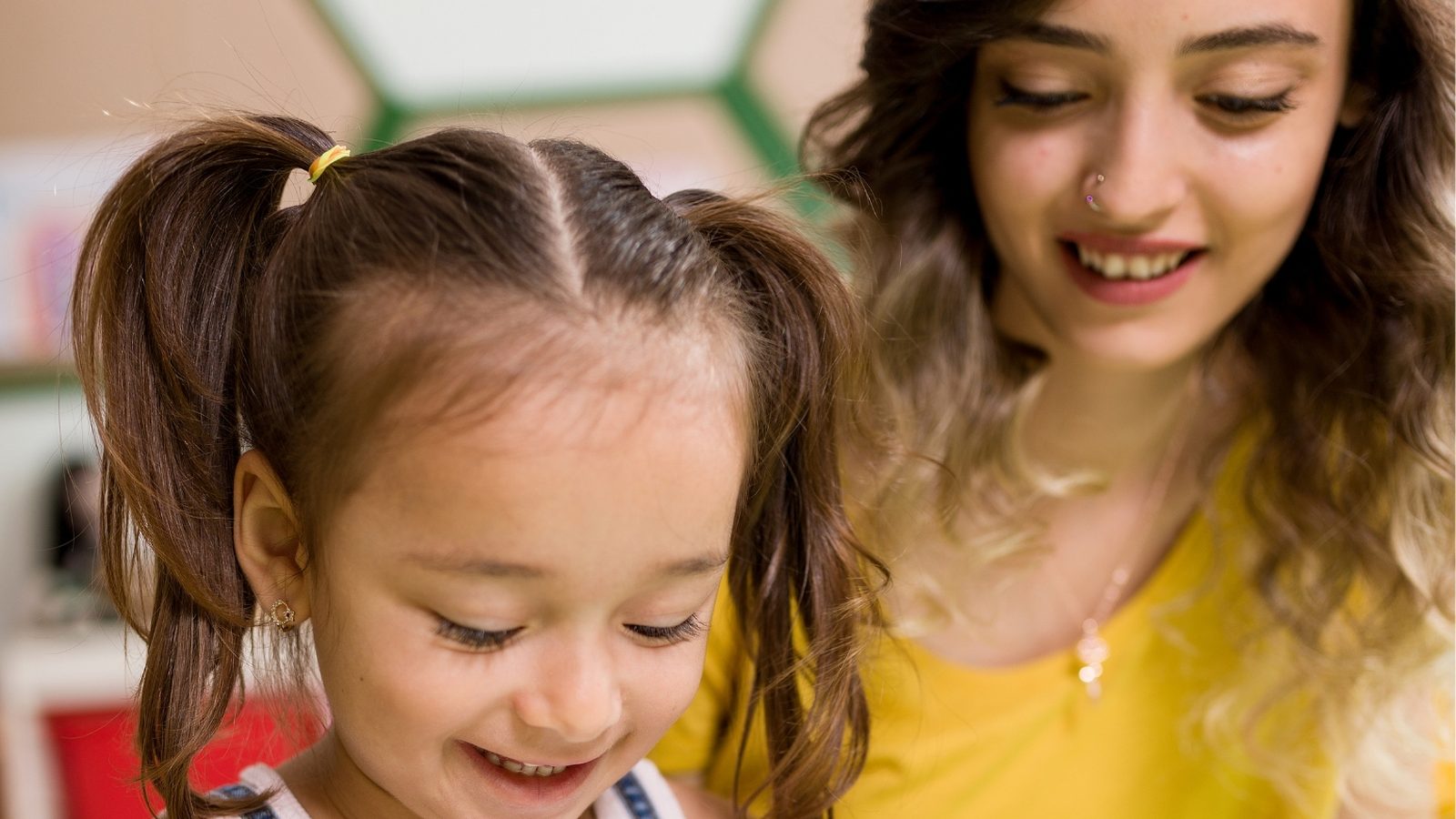 A girl drawing with her mother