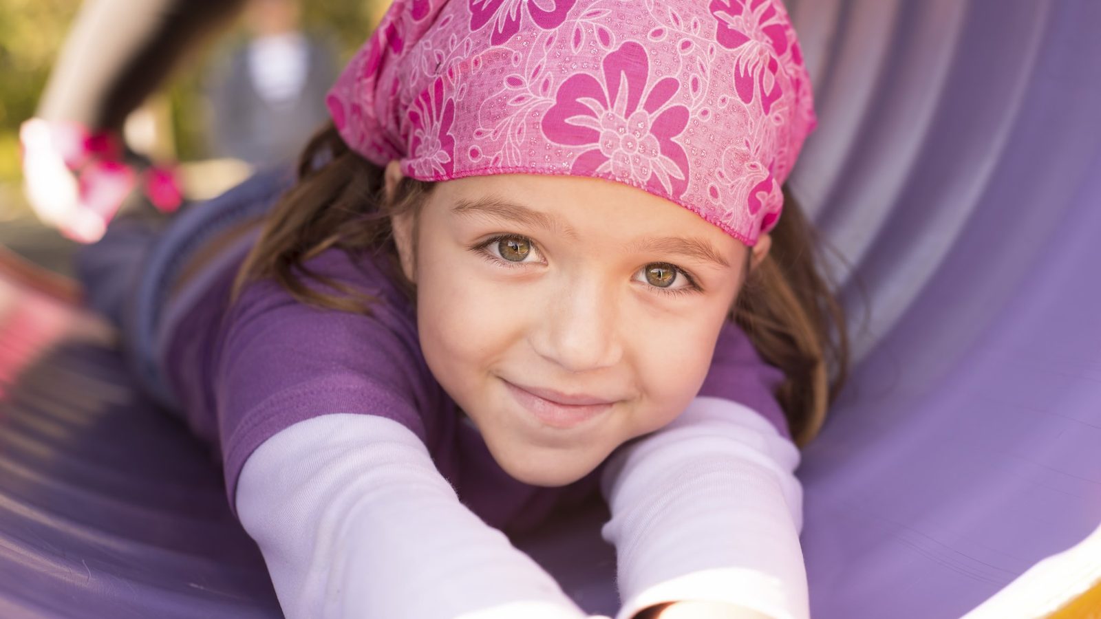 Smiling girl in a pink headscarf