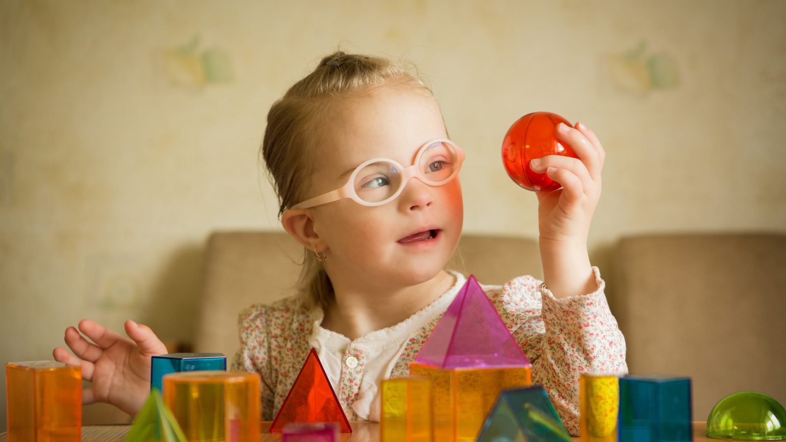 A girl sorting colourful shapes