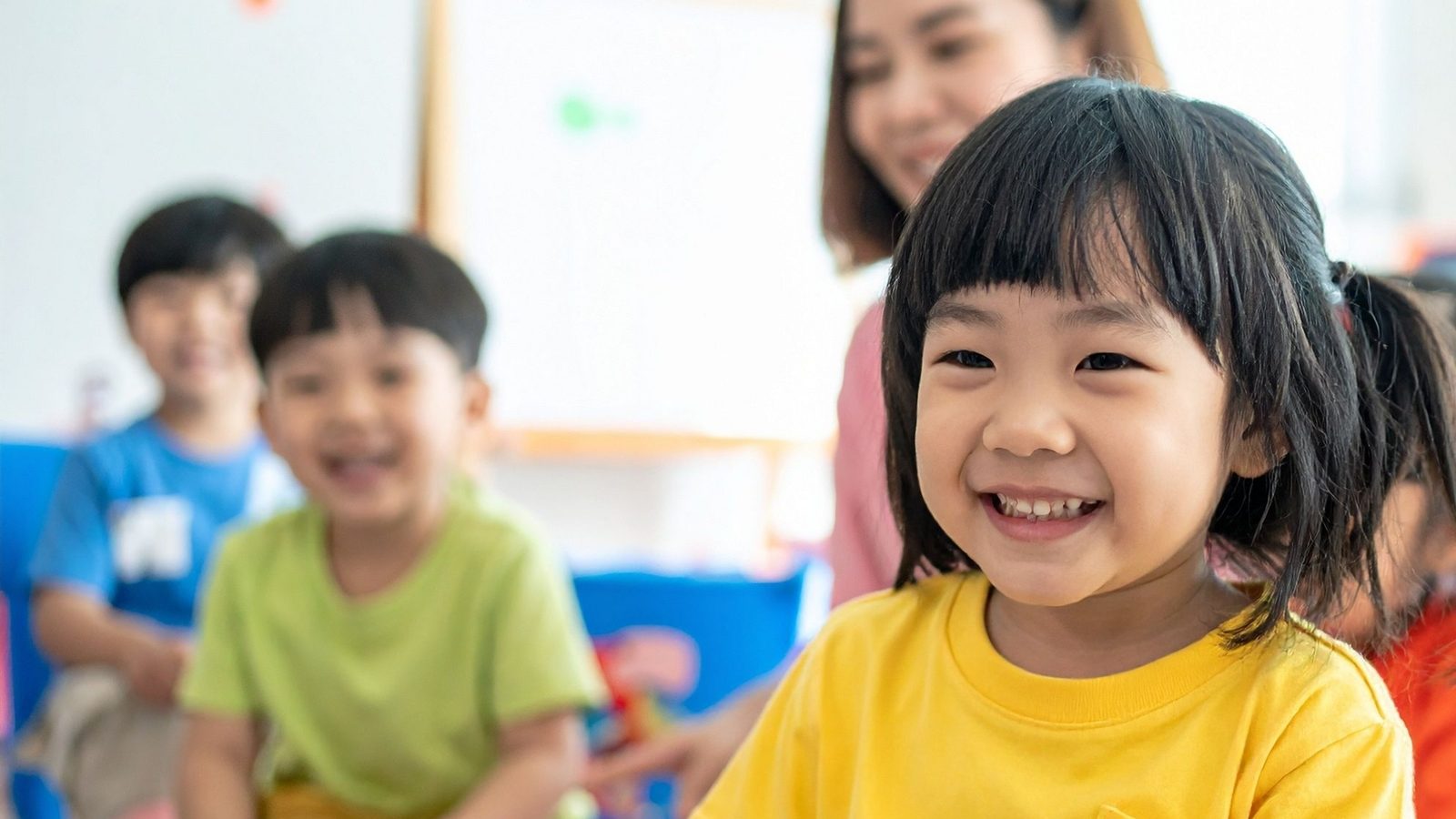 Smiling young children in a kindergarten classroom