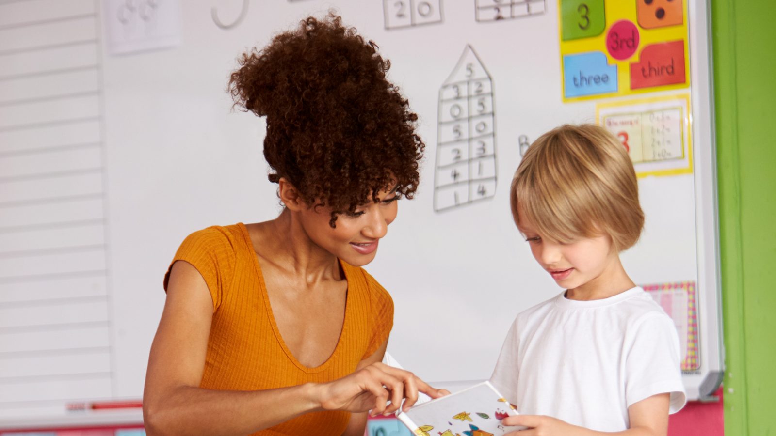 A teacher sharing a story with preschool children