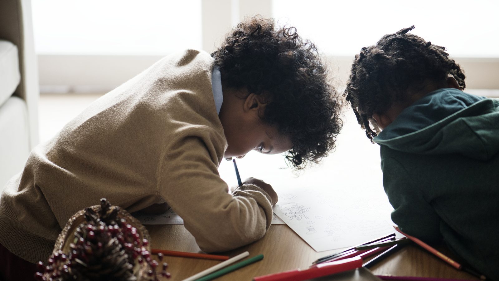 Children concentrating on a drawing activity