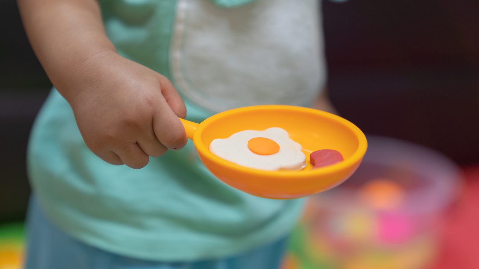 Hand holding a toy frying pan