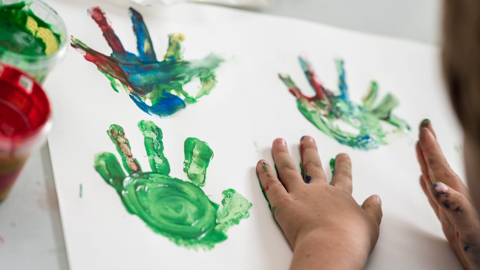 Painted handprints on paper