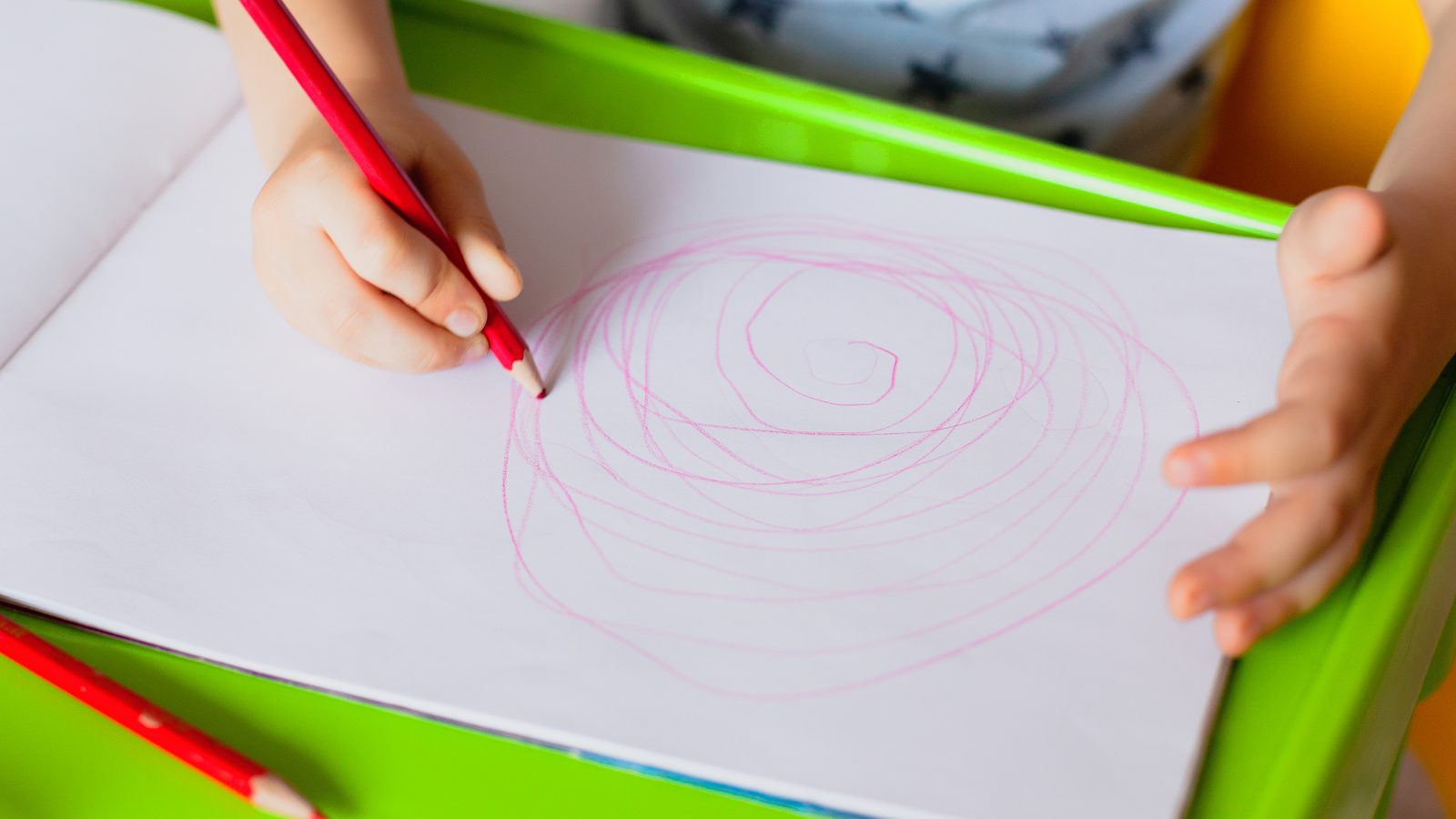 Hand drawing circles with a red pencil